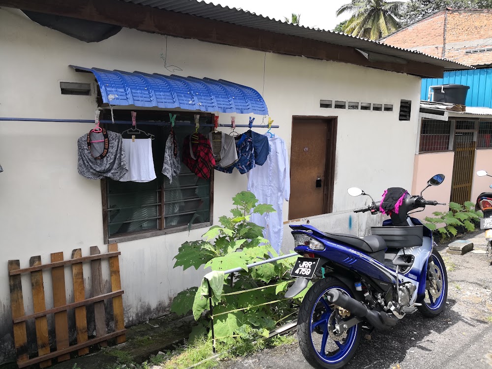 White house with motorcycle at front — House 112, bilik sewa pekerja di Taman Senai Baru, Senai